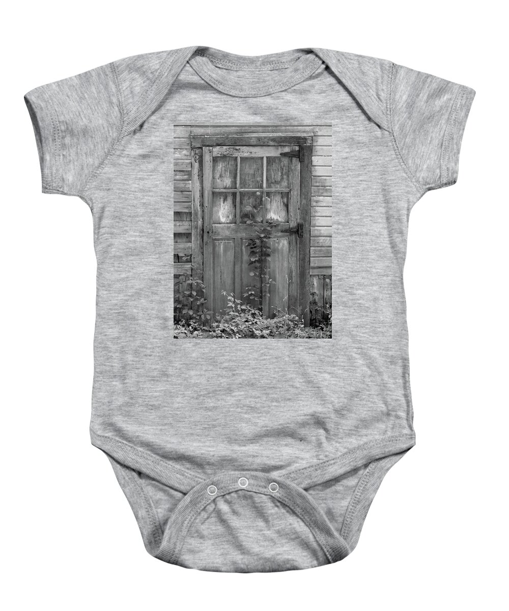 Black And White Barn Baby Onesie featuring the photograph Weathered Wood Barn Door with Vine by David Letts