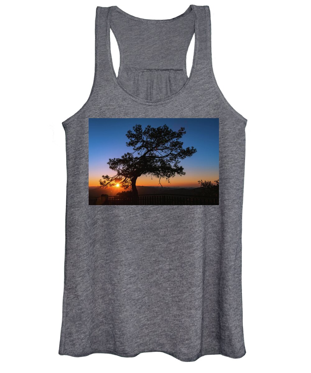 Cyprus Women's Tank Top featuring the photograph Silhouette of a forest pine tree during blue hour with bright sun at sunset. by Michalakis Ppalis