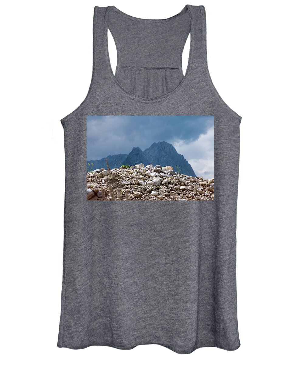Mountains Women's Tank Top featuring the photograph Stony hill with plants in front of a mountain range. by Bernhard Schaffer