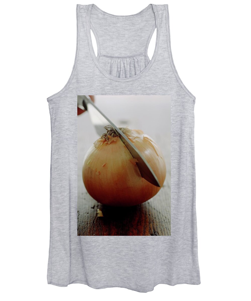 Fruits Women's Tank Top featuring the photograph A Raw Onion Being Cut In Half by Romulo Yanes
