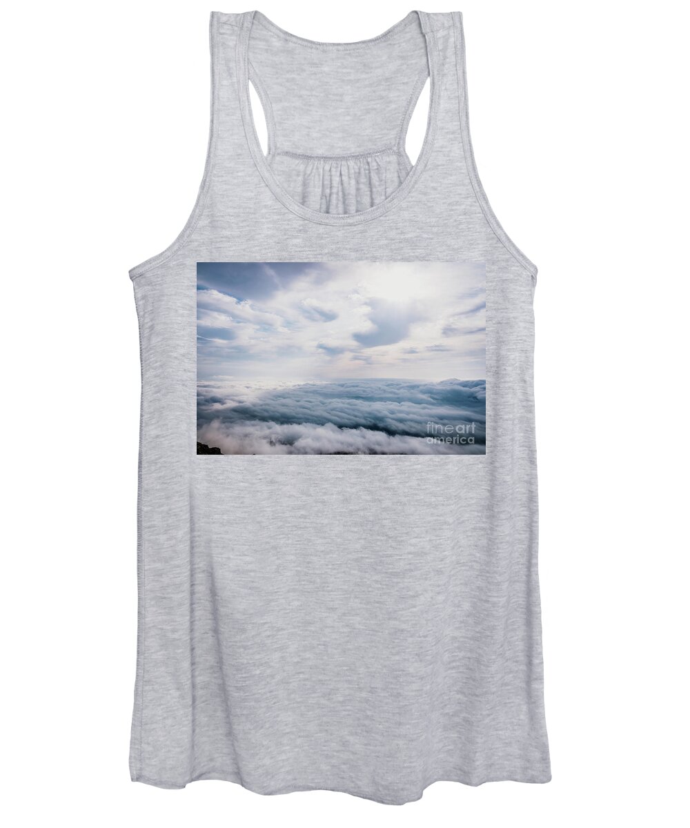 Above Women's Tank Top featuring the photograph Awesome view on top of the clouds on a cloudy morning. by Joaquin Corbalan