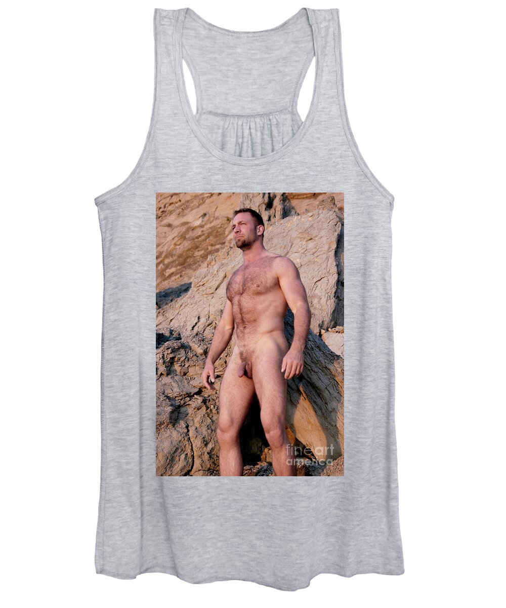 Nude Women's Tank Top featuring the photograph Naked man with muscles and a hairy body stands in front of rocks. by Gunther Allen