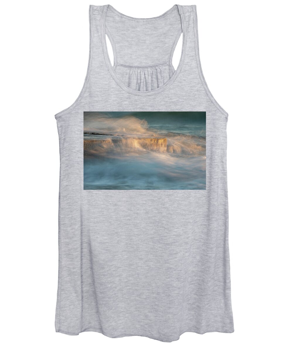Stormy Sea Women's Tank Top featuring the photograph Stormy windy sea waves splashing on a rocky seashore at sunset by Michalakis Ppalis