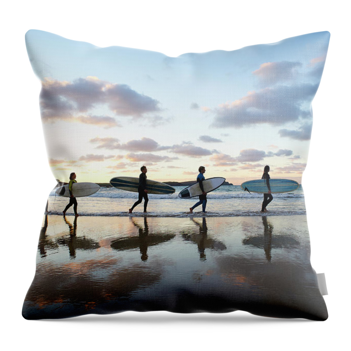 Young Men Throw Pillow featuring the photograph Five Surfers Walk Along Beach With Surf by Dougal Waters