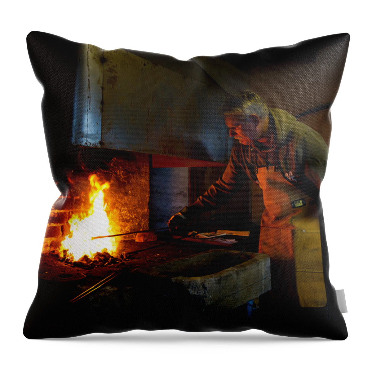 The Torresta Blacksmith Throw Pillow featuring the photograph The Torresta Blacksmith by Torbjorn Swenelius
