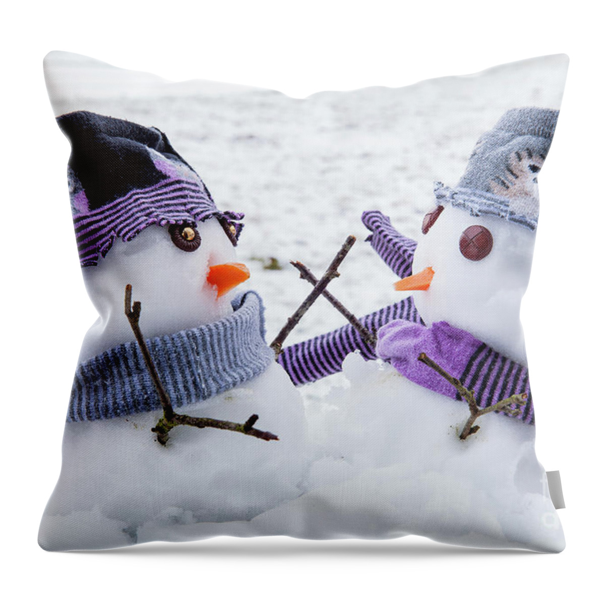 Snowmen Throw Pillow featuring the photograph Two cute snowmen friends embracing by Simon Bratt