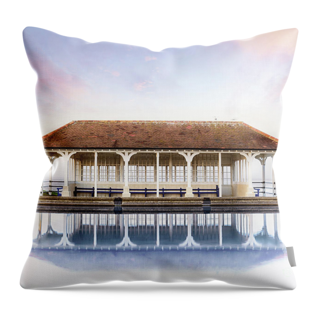 Sheringham Throw Pillow featuring the photograph Norfolk victorian seaside shelter with pink sunset sky by Simon Bratt
