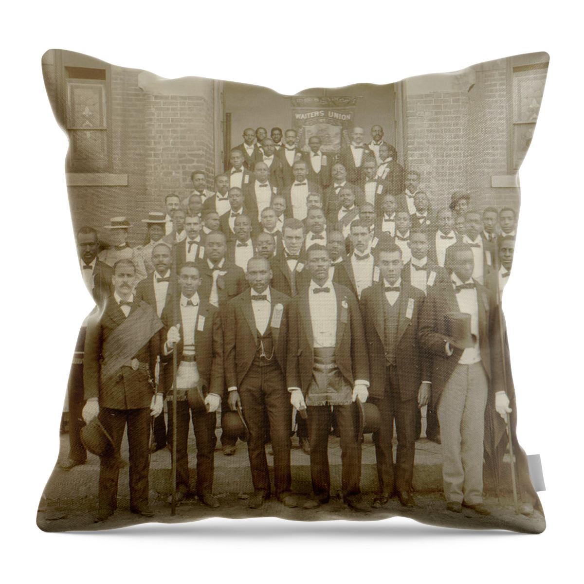 Negroes Throw Pillow featuring the painting African American men posed at entrance to building, some with derbies and top hats, and banner labeled Waiters Union in Georgia by Unknown