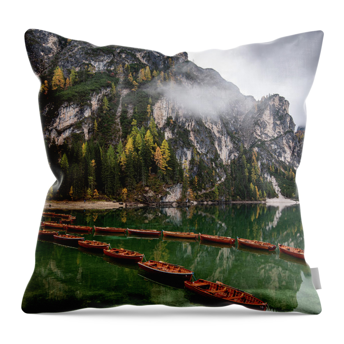 Lago Di Braies Throw Pillow featuring the photograph Wooden boats on the peaceful lake. Lago di braies, Italy by Michalakis Ppalis