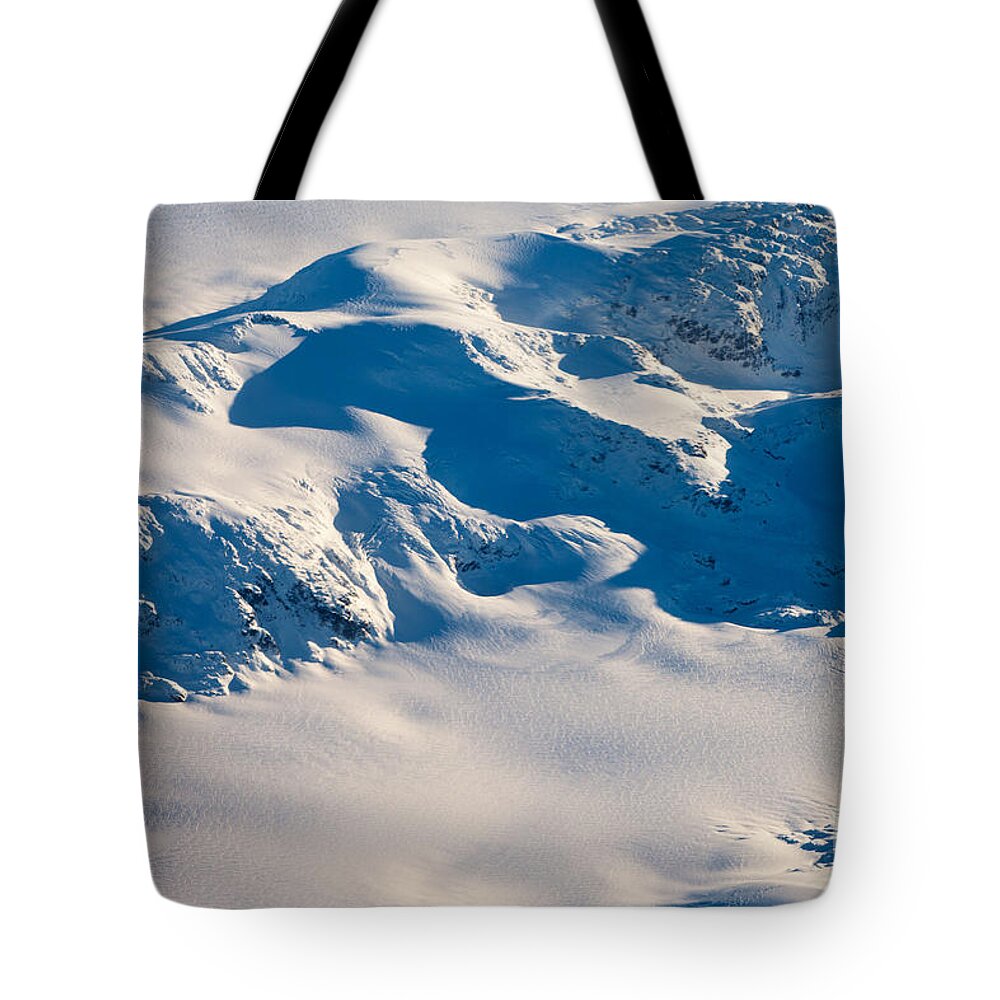 Aerial Tote Bag featuring the photograph Aerial view of snowcapped peaks in BC Canada #1 by Stephan Pietzko