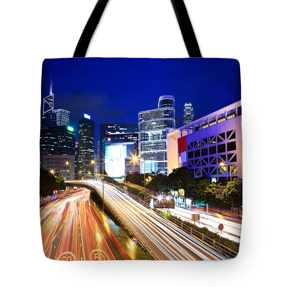 Financial Building Tote Bag featuring the photograph City At Night With Traffic Trails #1 by Ngkaki