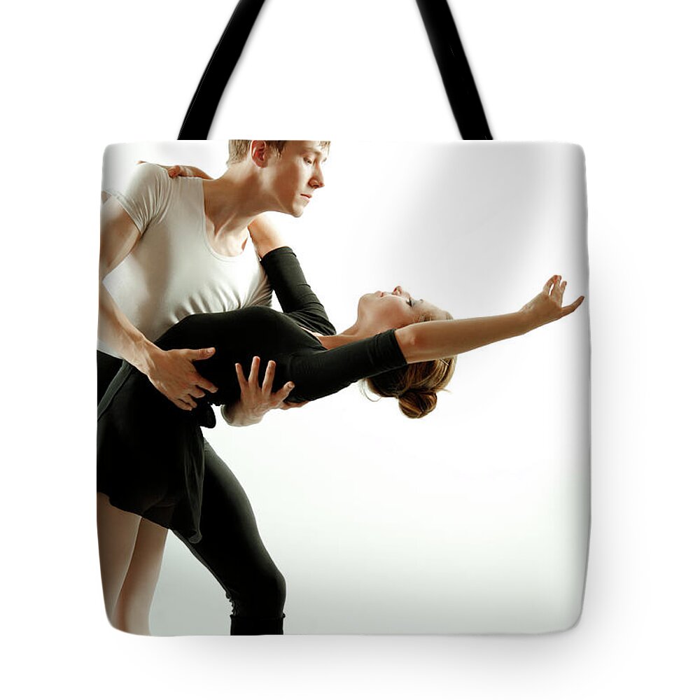 Young Men Tote Bag featuring the photograph Couple Dancing Ballet #1 by Oleg66