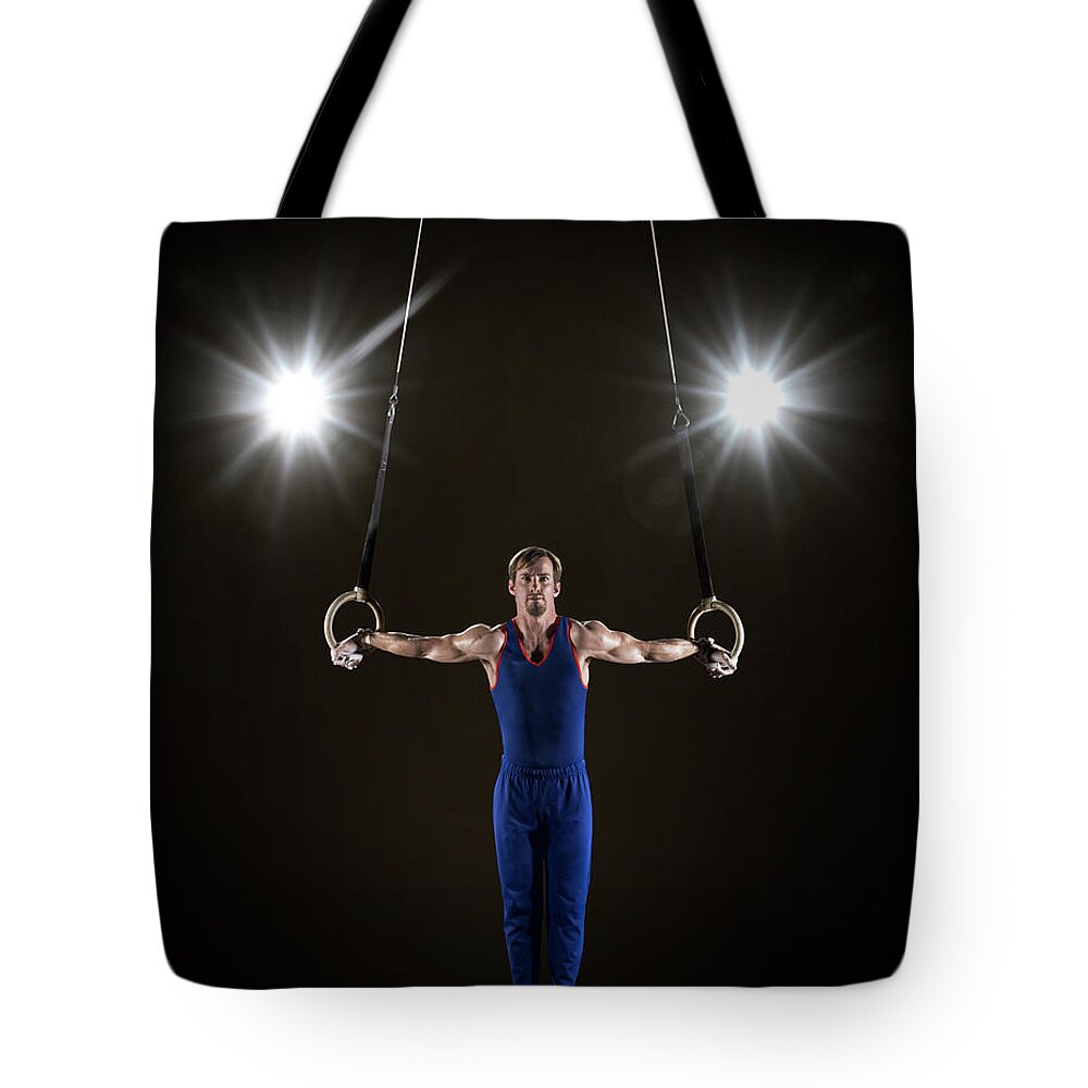 Focus Tote Bag featuring the photograph Male Gymnast On Rings #1 by Mike Harrington