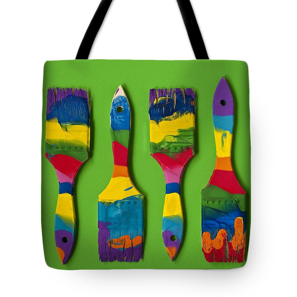Abstract Tote Bag featuring the photograph Multicolored paint brushes on green background #2 by Jim Corwin
