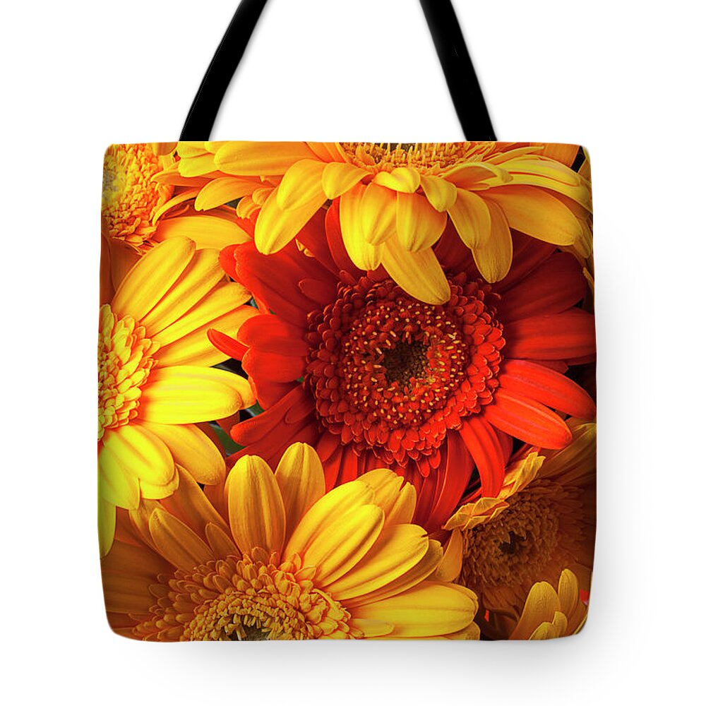 Orange Color Tote Bag featuring the photograph Orange Gerbera Among Yellow Ones #1 by Garry Gay
