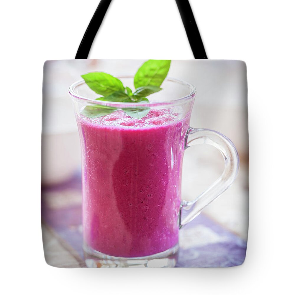 Purple Tote Bag featuring the photograph Red Smoothie #1 by Drbouz