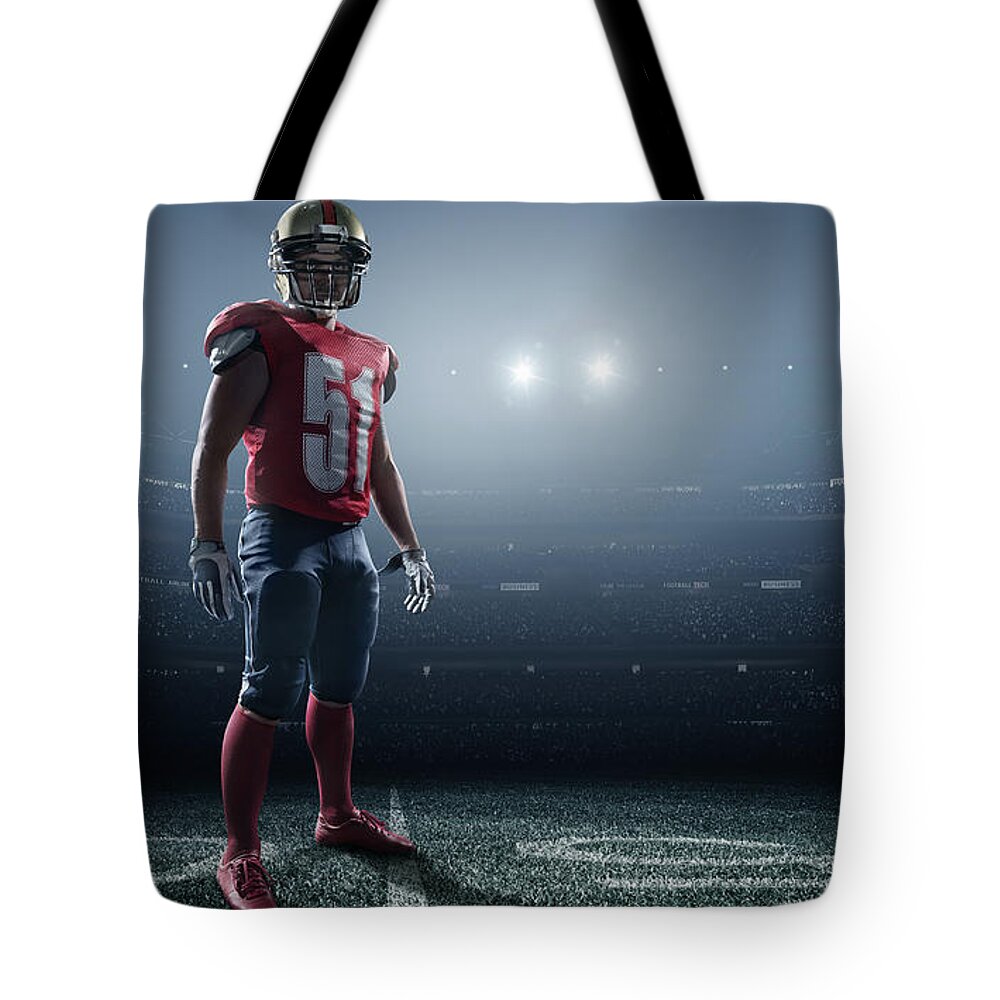 Soccer Uniform Tote Bag featuring the photograph American Football In Action #2 by Dmytro Aksonov