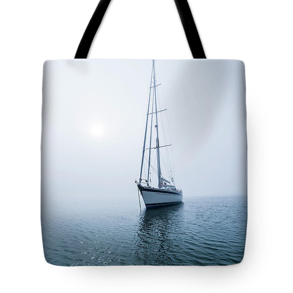 Tranquility Tote Bag featuring the photograph 62 Ft Sailboat Anchored In Fog Off by Gary S Chapman