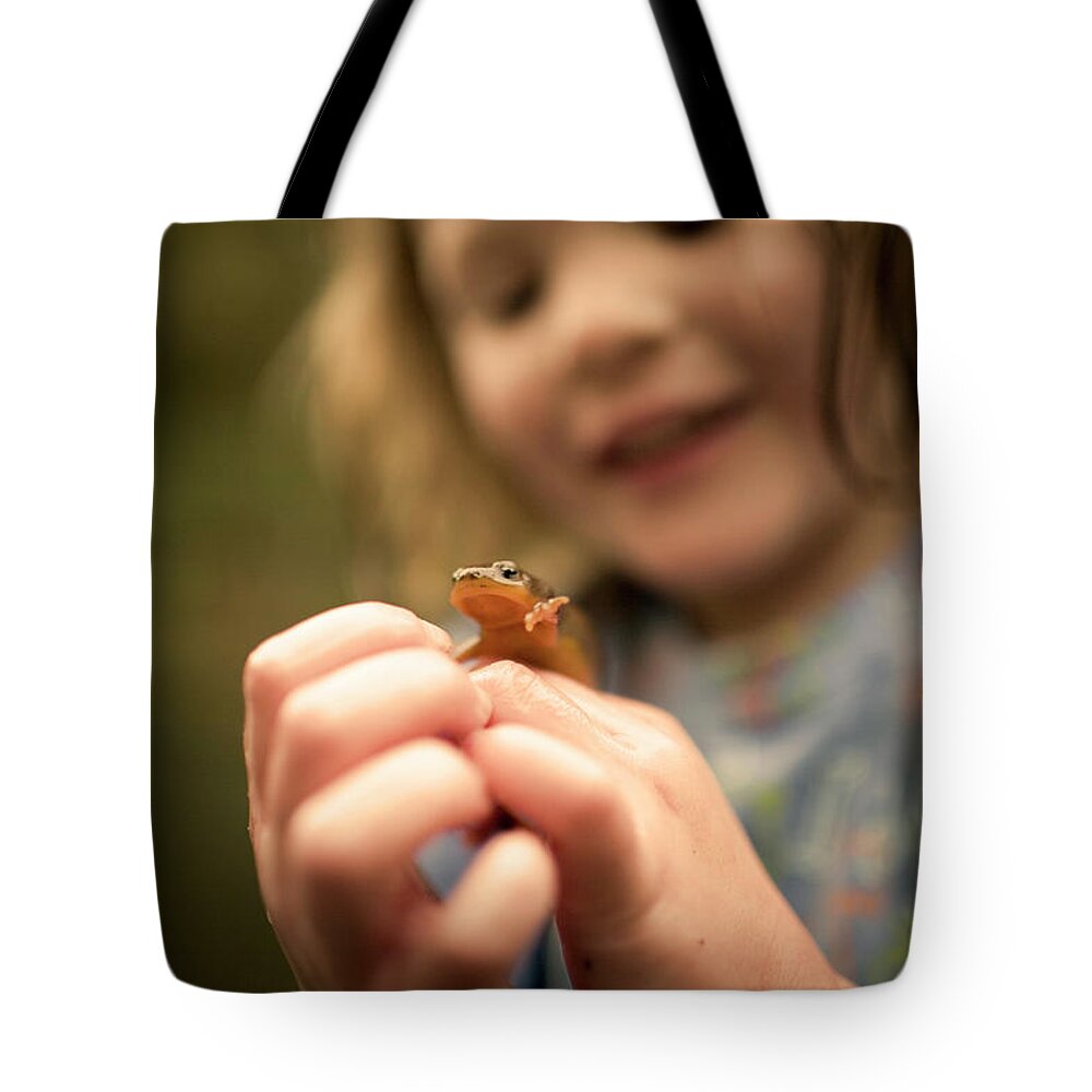 Child Tote Bag featuring the photograph A Girl Holds A Salamander by Jan Sonnenmair