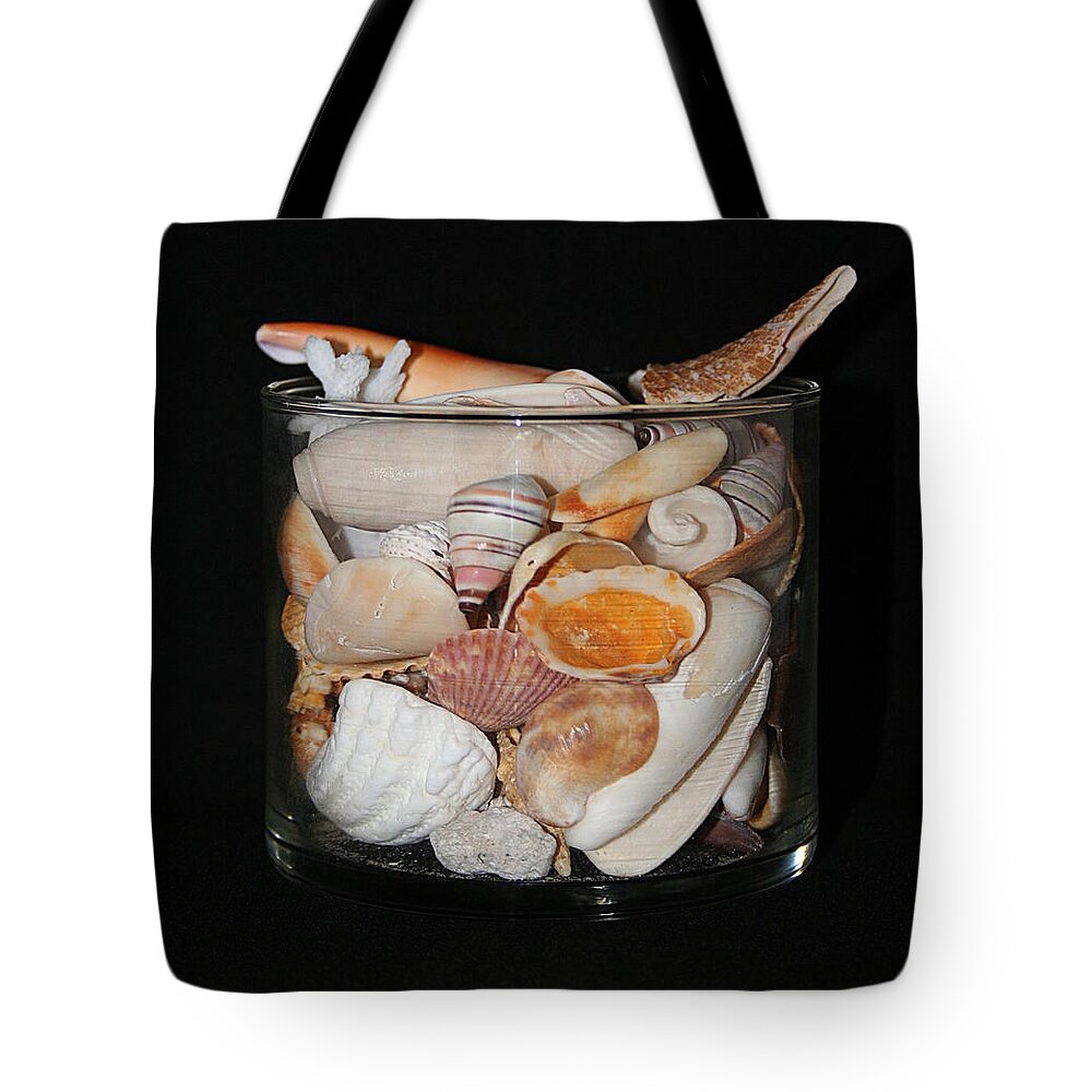Shells Photographs Tote Bag featuring the photograph A Glass Of Seashells by Ester McGuire