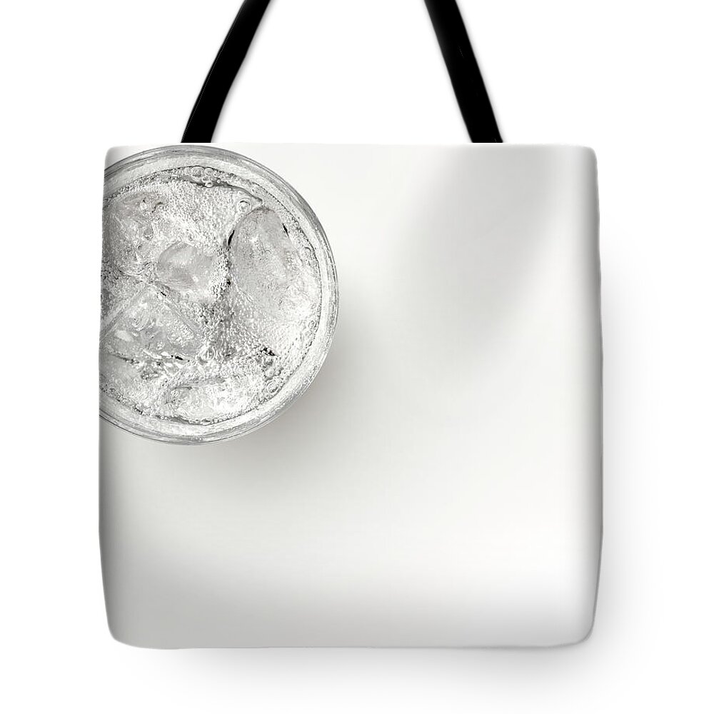 White Background Tote Bag featuring the photograph A Glass Of Sparkling Water With Ice by Anthony Bradshaw