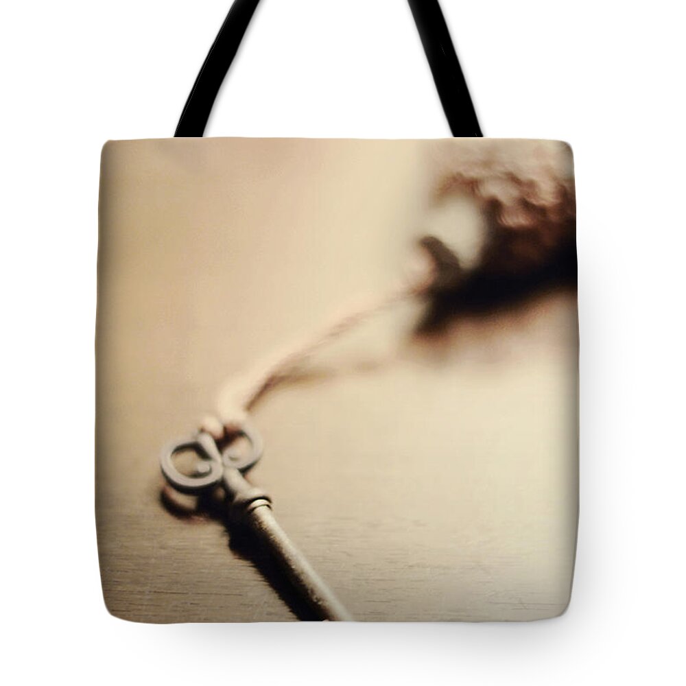 Key Tote Bag featuring the photograph A key... by Trish Mistric
