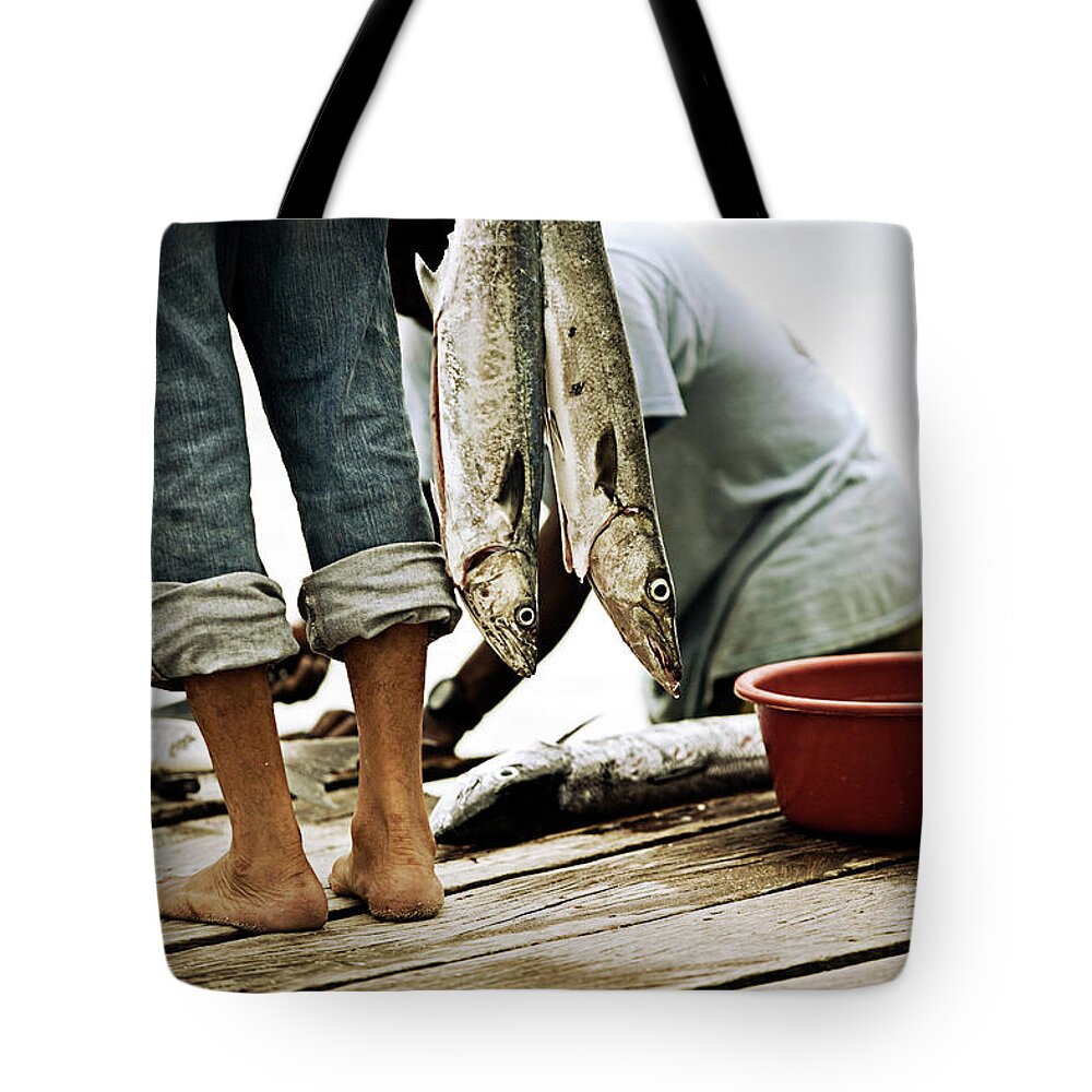 A Man With Rolled Up Pants Holds Fish Tote Bag by Chris Ross