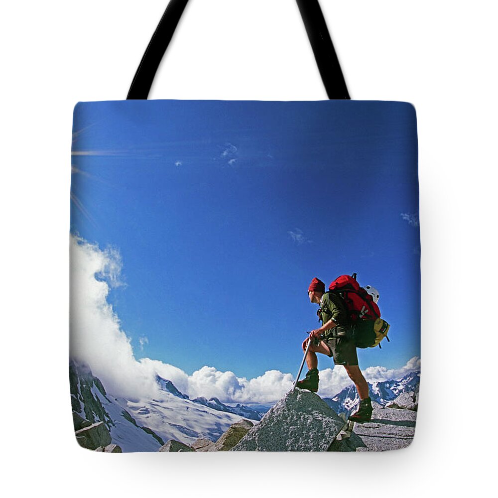 Adventure Tote Bag featuring the photograph A Mountaineer Checks His Route by Cliff Leight