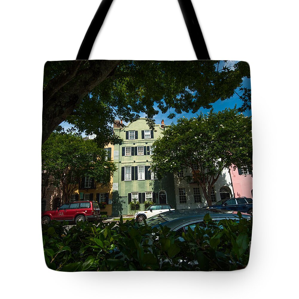 Rainbow Row Tote Bag featuring the photograph A Peek Through the Tree's by Dale Powell