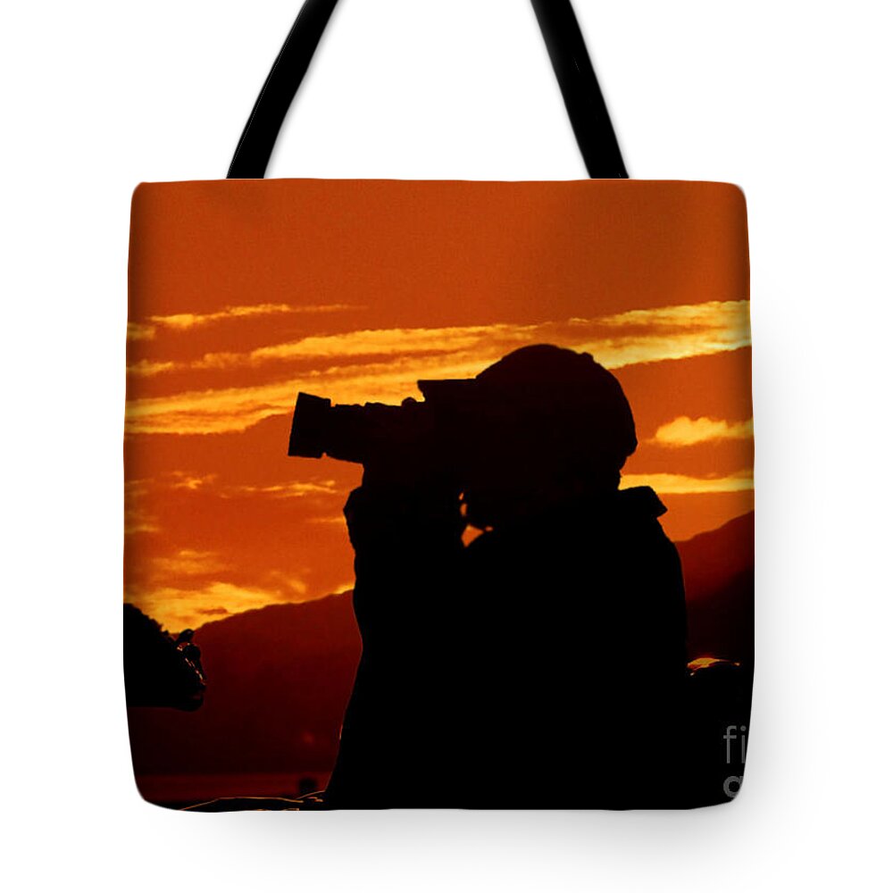 Sunset Tote Bag featuring the photograph A Photographer Enjoying His Work by Kathy Baccari