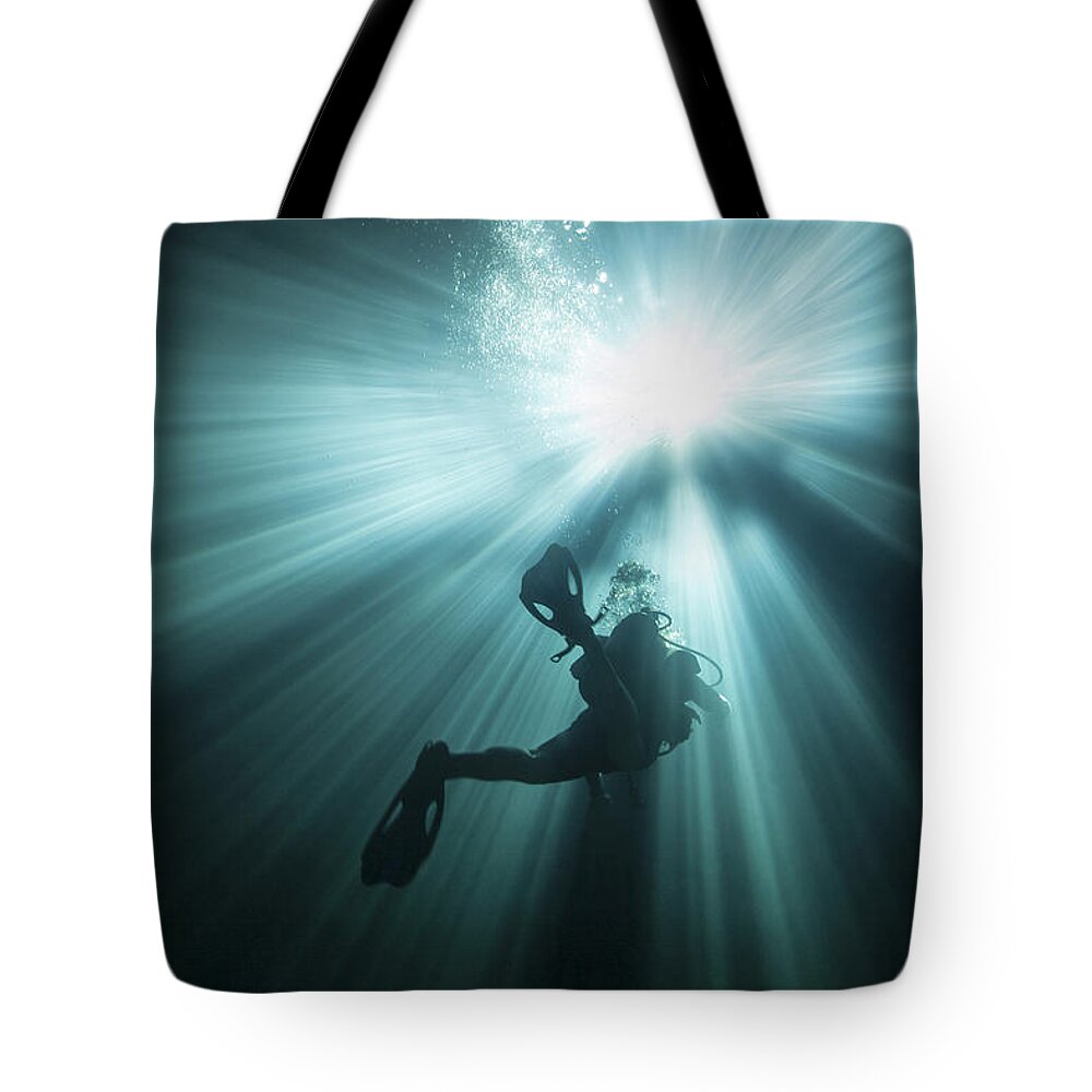 Scuba Diving Tote Bag featuring the photograph A Scuba Diver Ascends Into The Light by Michael Wood