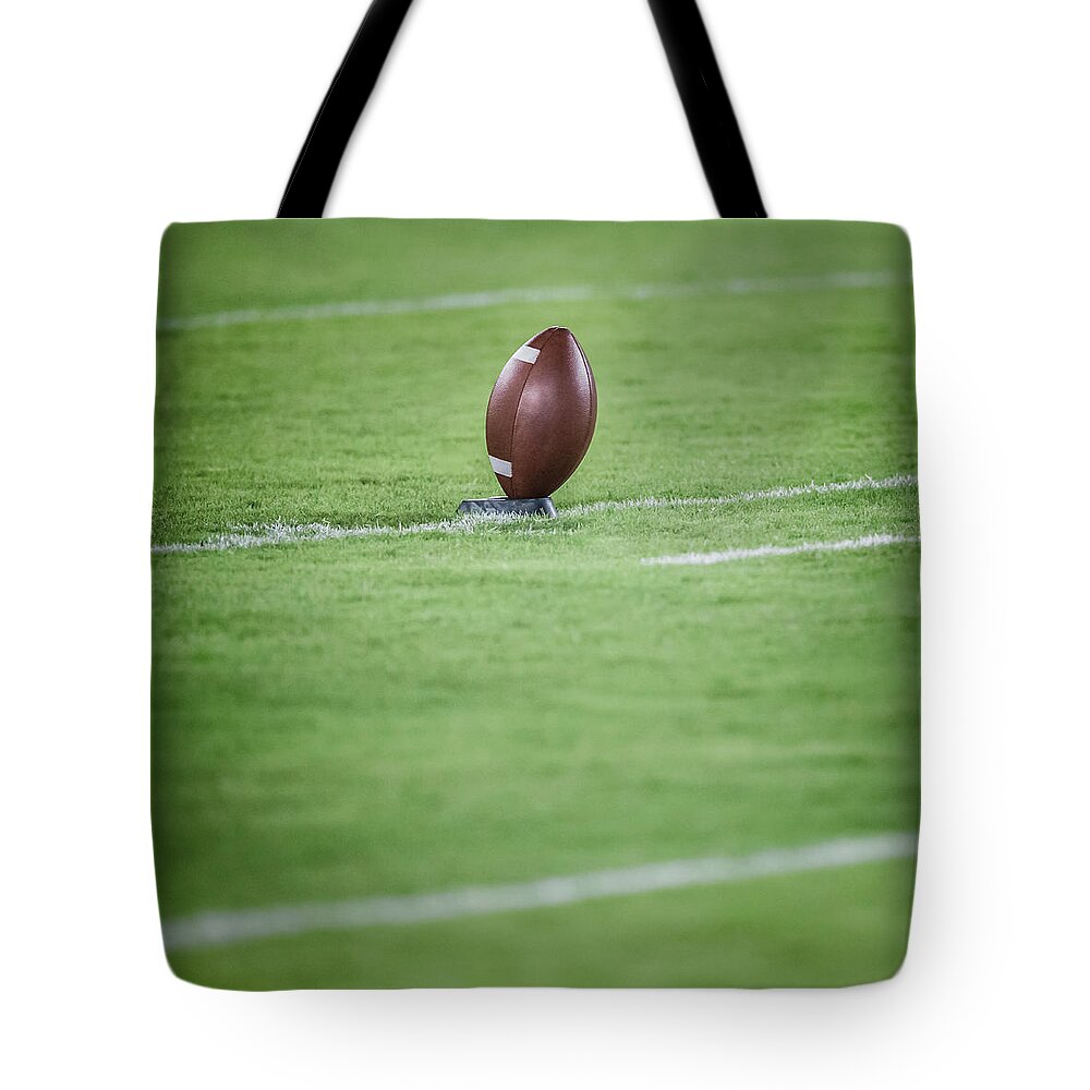 Grass Tote Bag featuring the photograph American Football On Tee by David Madison