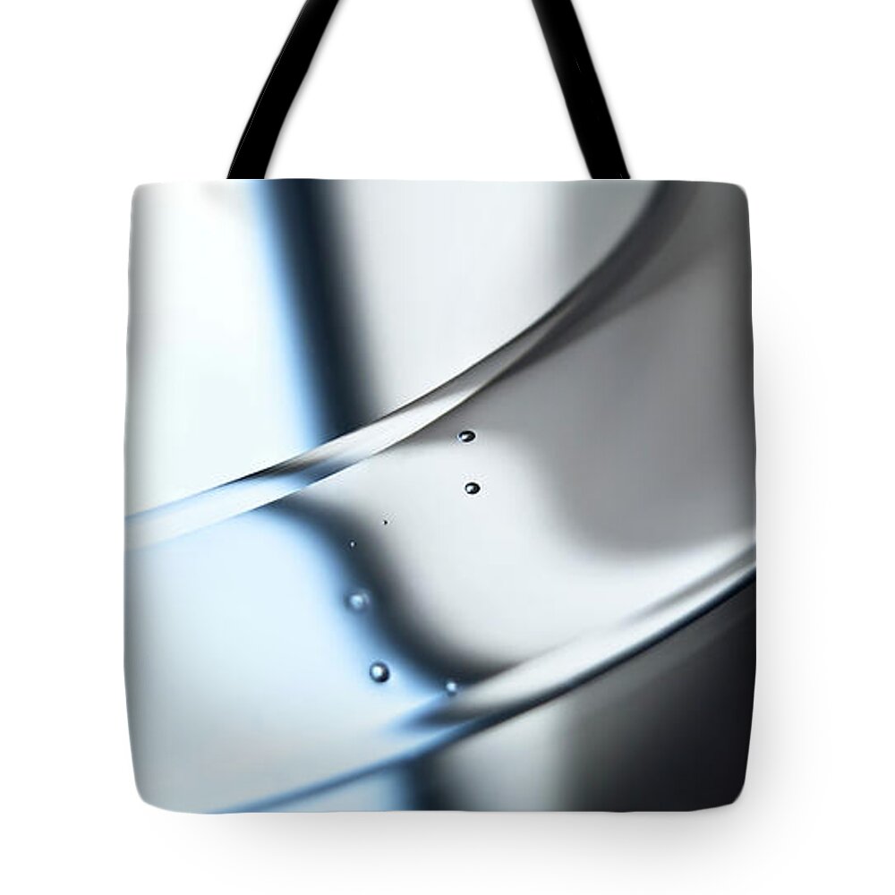 Curve Tote Bag featuring the photograph An Abstract Shiny Silver Surface With by Ralf Hiemisch