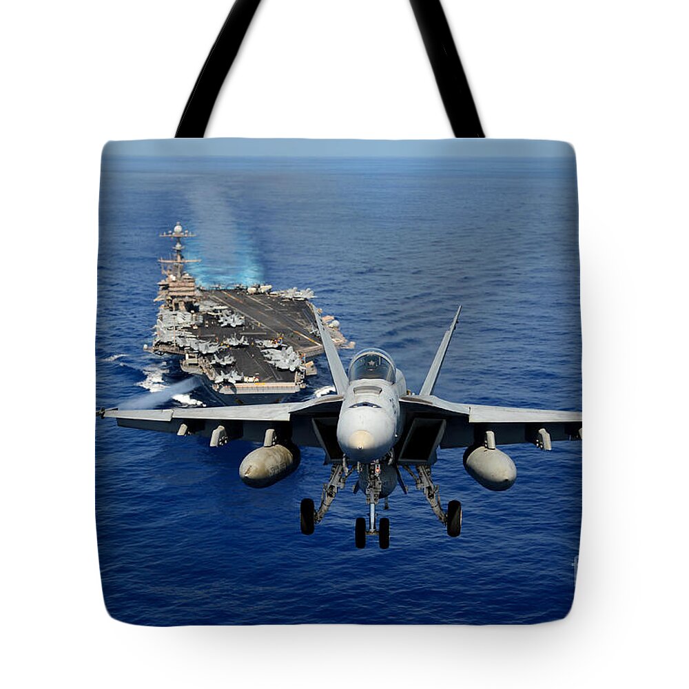 F A 18e Tote Bag featuring the photograph An FA-18 Hornet demonstrates air power. by Paul Fearn