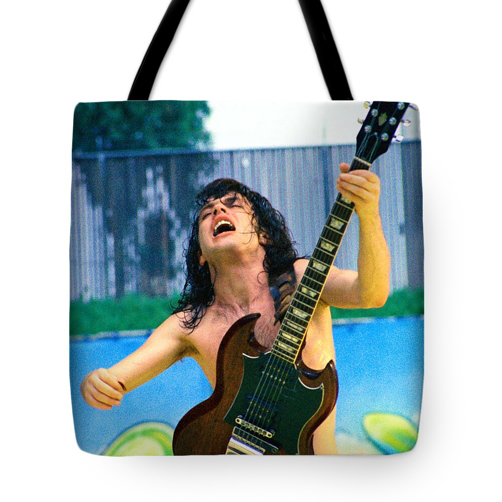 Angus Young Tote Bag featuring the photograph Angus Young of A C D C at Day on the Green Monsters of Rock 7-21-79 by Daniel Larsen