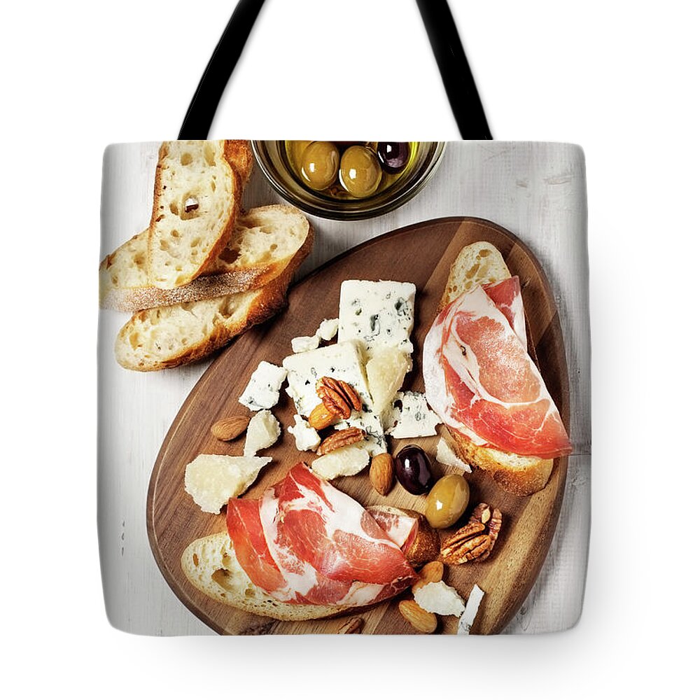 Nut Tote Bag featuring the photograph Appetizer On A Cutting Board by Claudia Totir