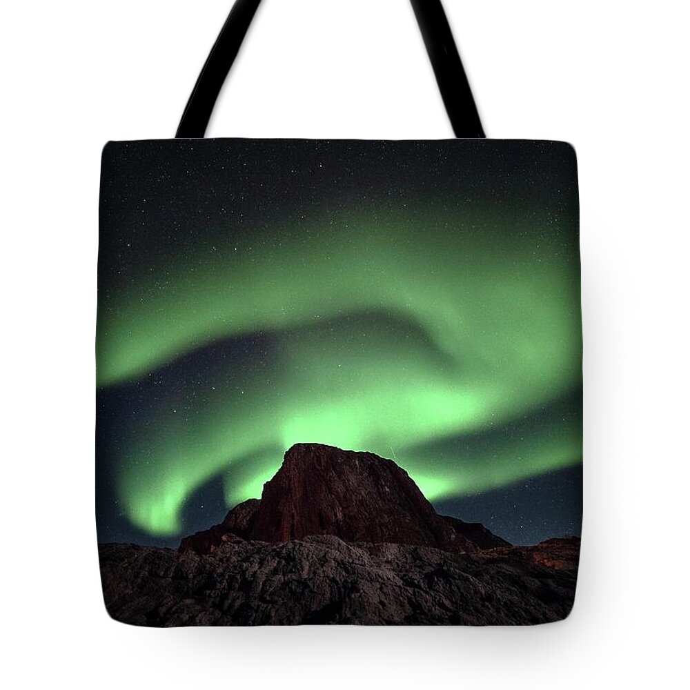 Tranquility Tote Bag featuring the photograph Aurora Spins And Twists by Tommy Johansen. Freelance Photographer In Lofoten Norway.