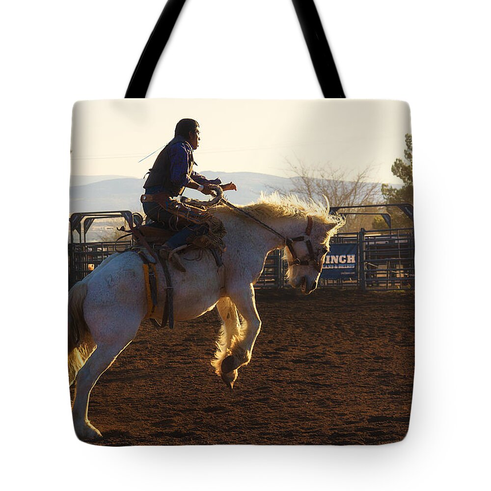 Rodeo Tote Bag featuring the photograph Backlit Bucking Bronco by Priscilla Burgers