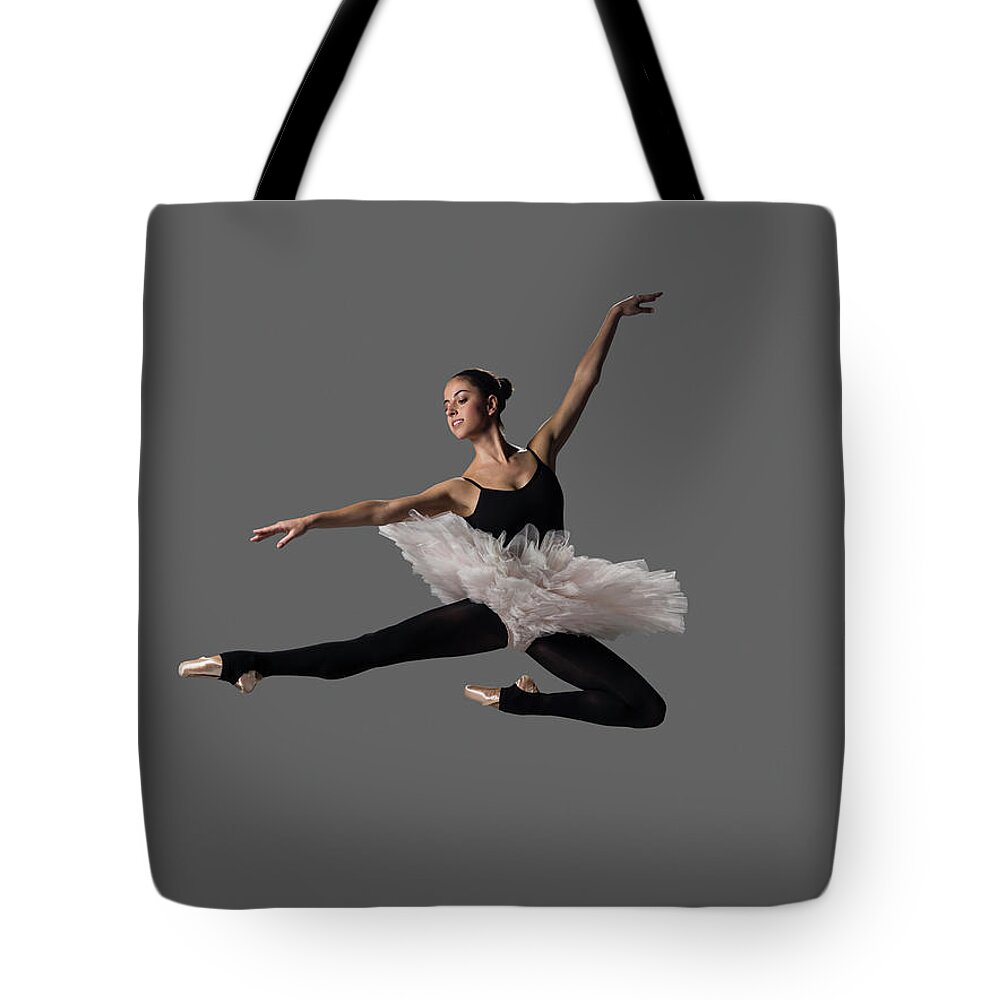 Ballet Dancer Tote Bag featuring the photograph Ballerina Performing Pas De Chat by Nisian Hughes