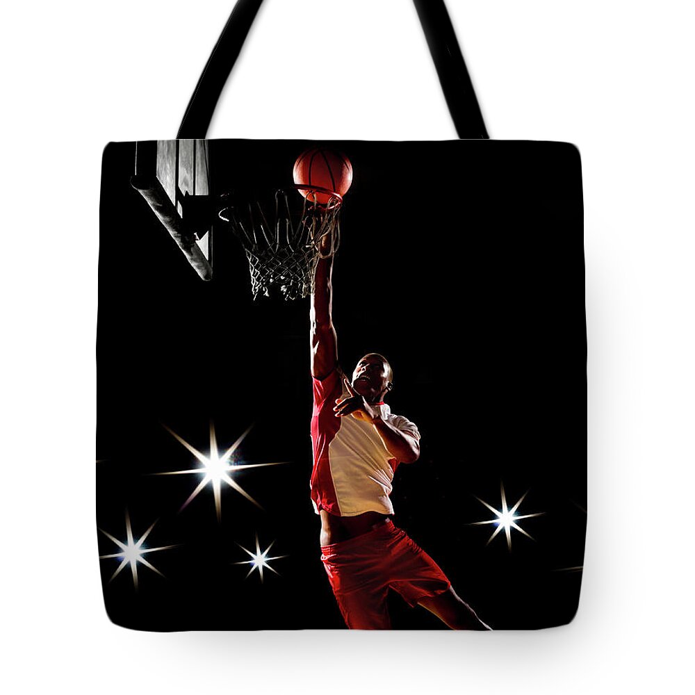 Three Quarter Length Tote Bag featuring the photograph Basketball Player Dunking Basketball On by Compassionate Eye Foundation/chris Newton