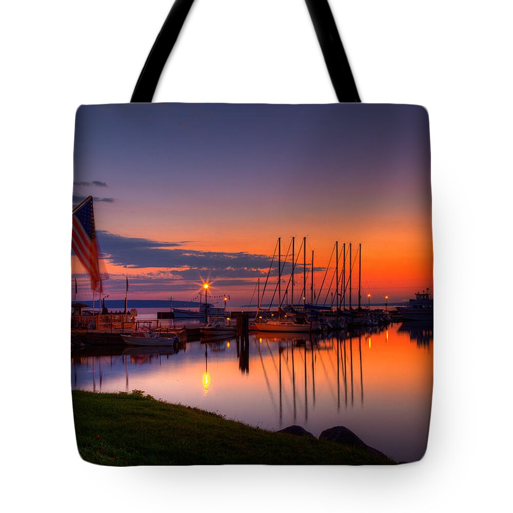 Apostle Islands Tote Bag featuring the photograph Bayfield Wisconsin Fire in the sky over the harbor by Wayne Moran