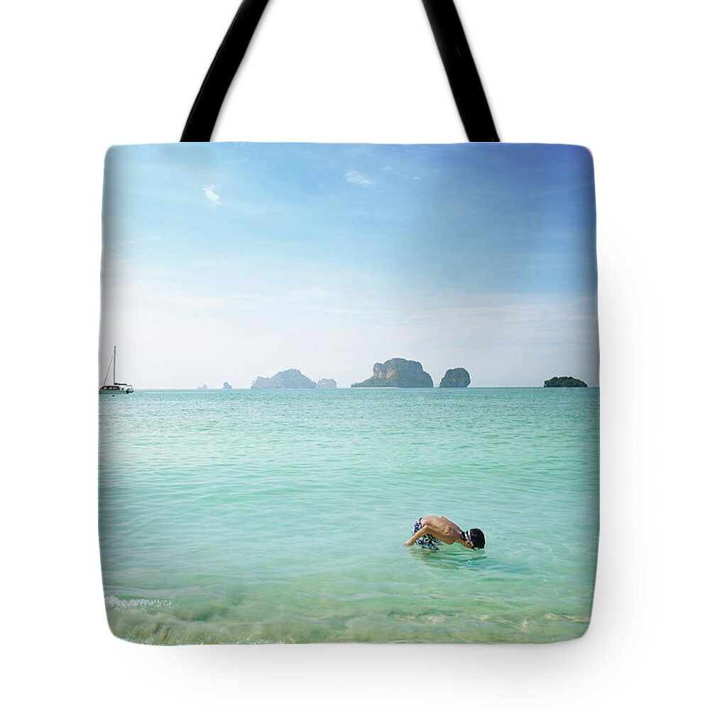 Diving Into Water Tote Bag featuring the photograph Boy Exploring Water With Diving Goggles by Elisabeth Schmitt