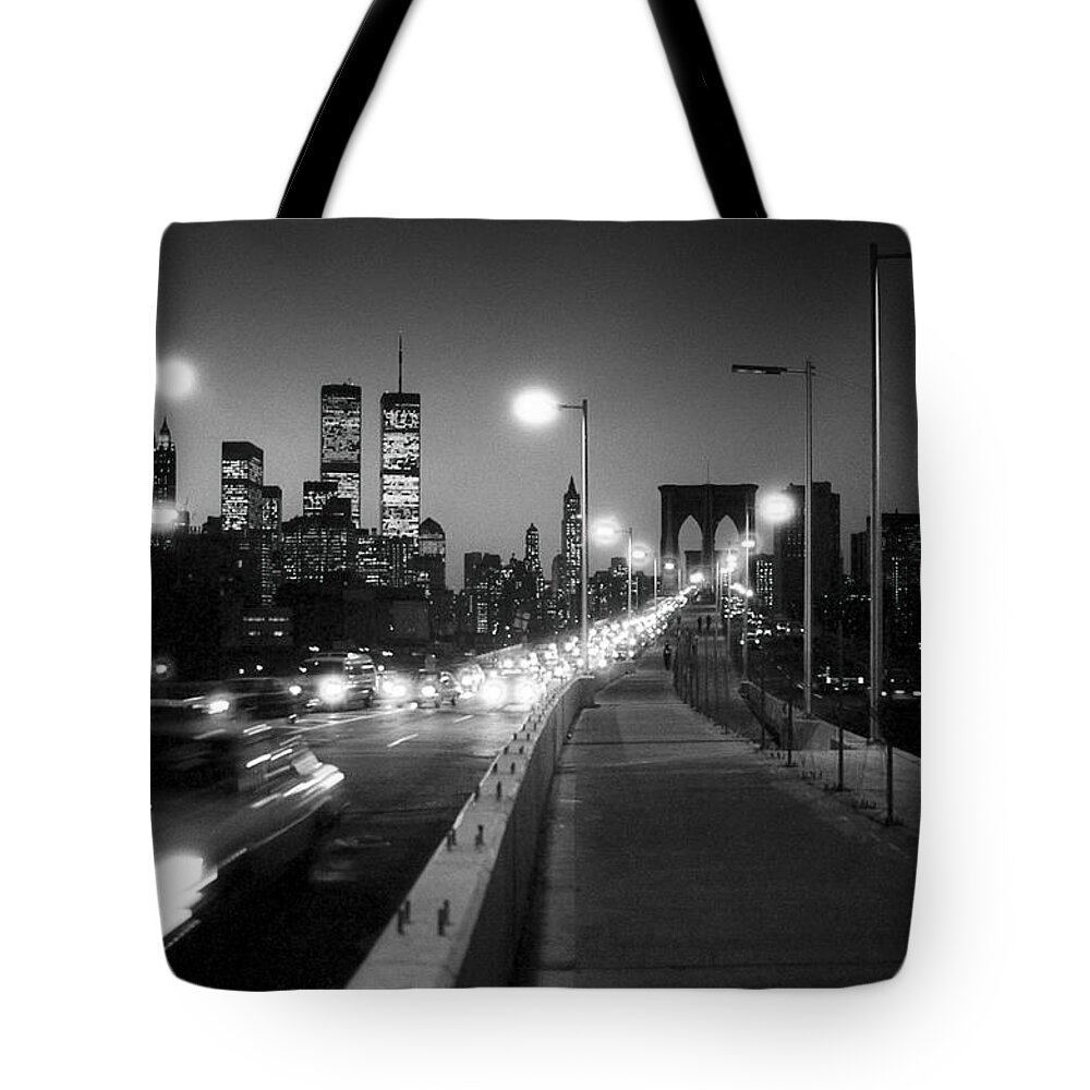 1980s Tote Bag featuring the photograph Brooklyn Bridge and Manhattan skyline at dusk 1980s by Gary Eason