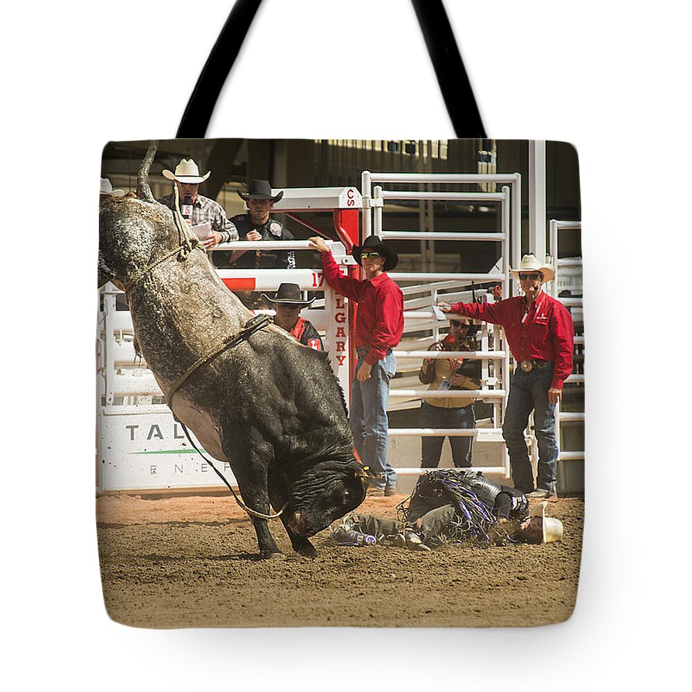 2014 Tote Bag featuring the photograph Bull One and the Rider Nothing by Bill Cubitt