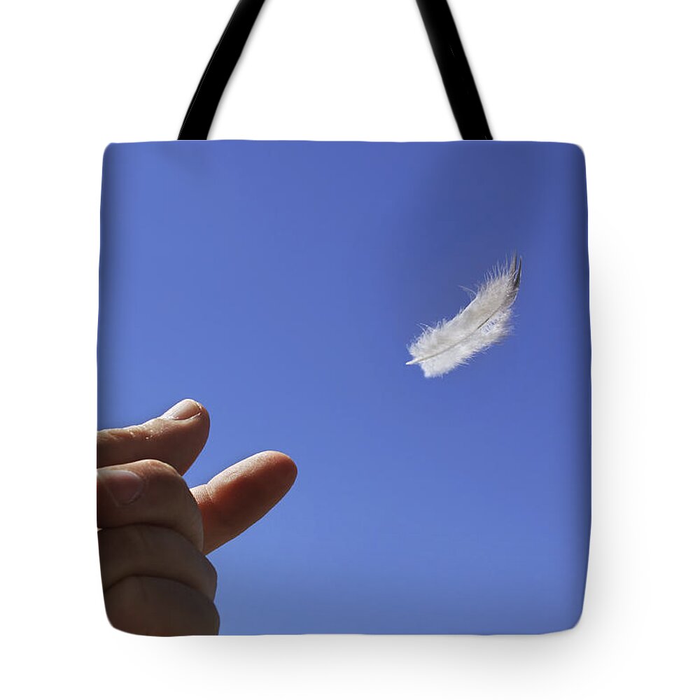 Feather Tote Bag featuring the photograph Carried on Wind by Jason Politte