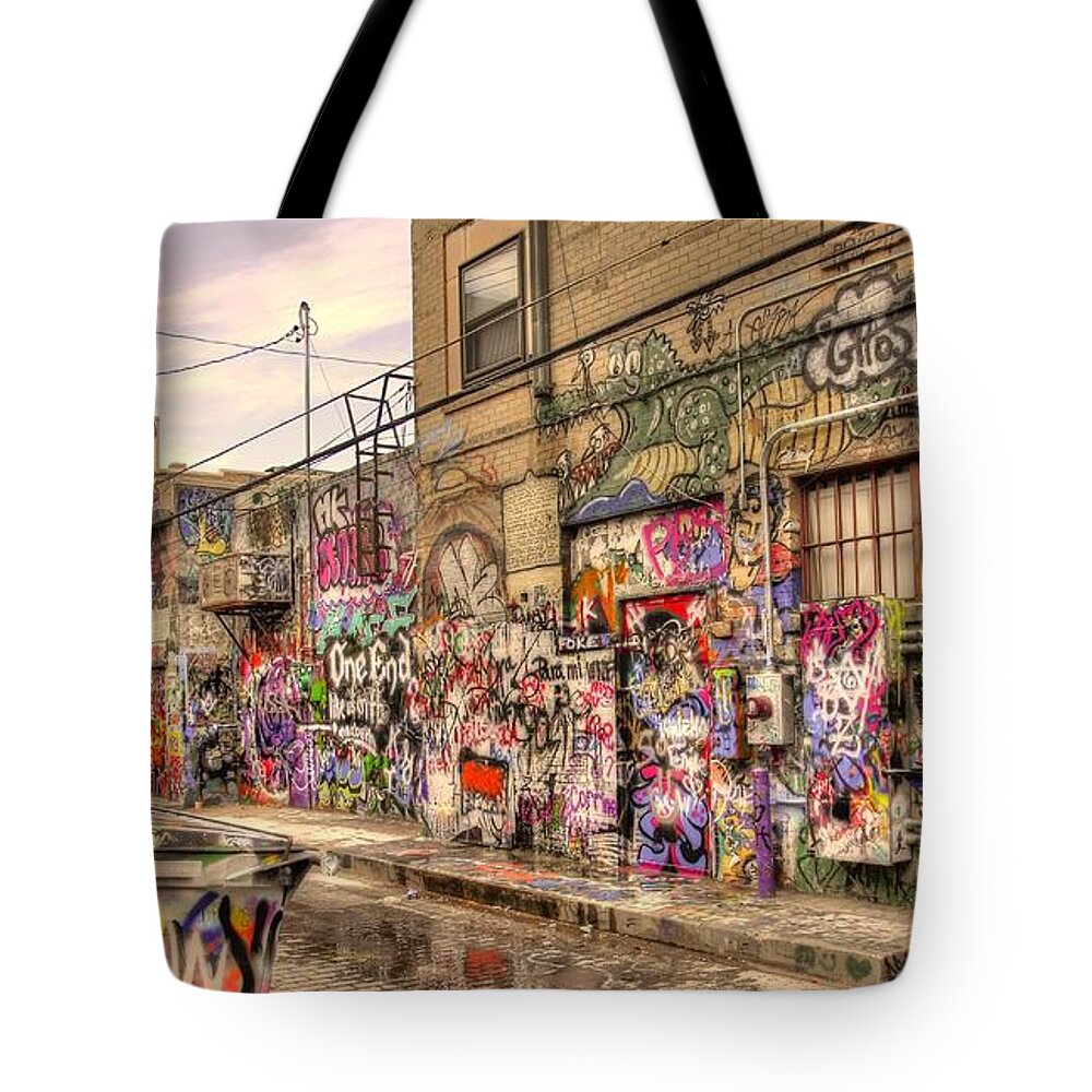 Graffiti Tote Bag featuring the photograph Caution Wet Paint by Anthony Wilkening