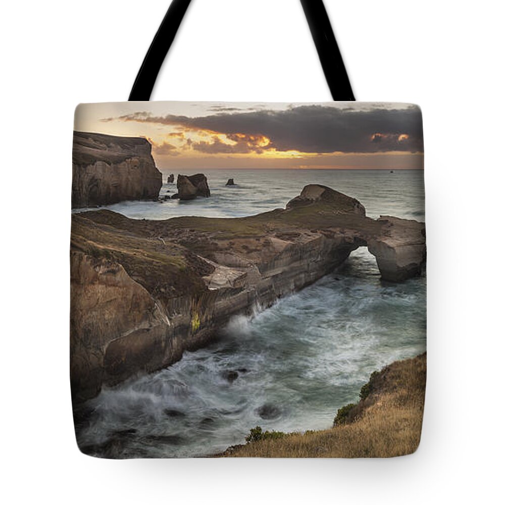 Colin Monteath Tote Bag featuring the photograph Cliffs And Tunnel Beach Otago New by Colin Monteath