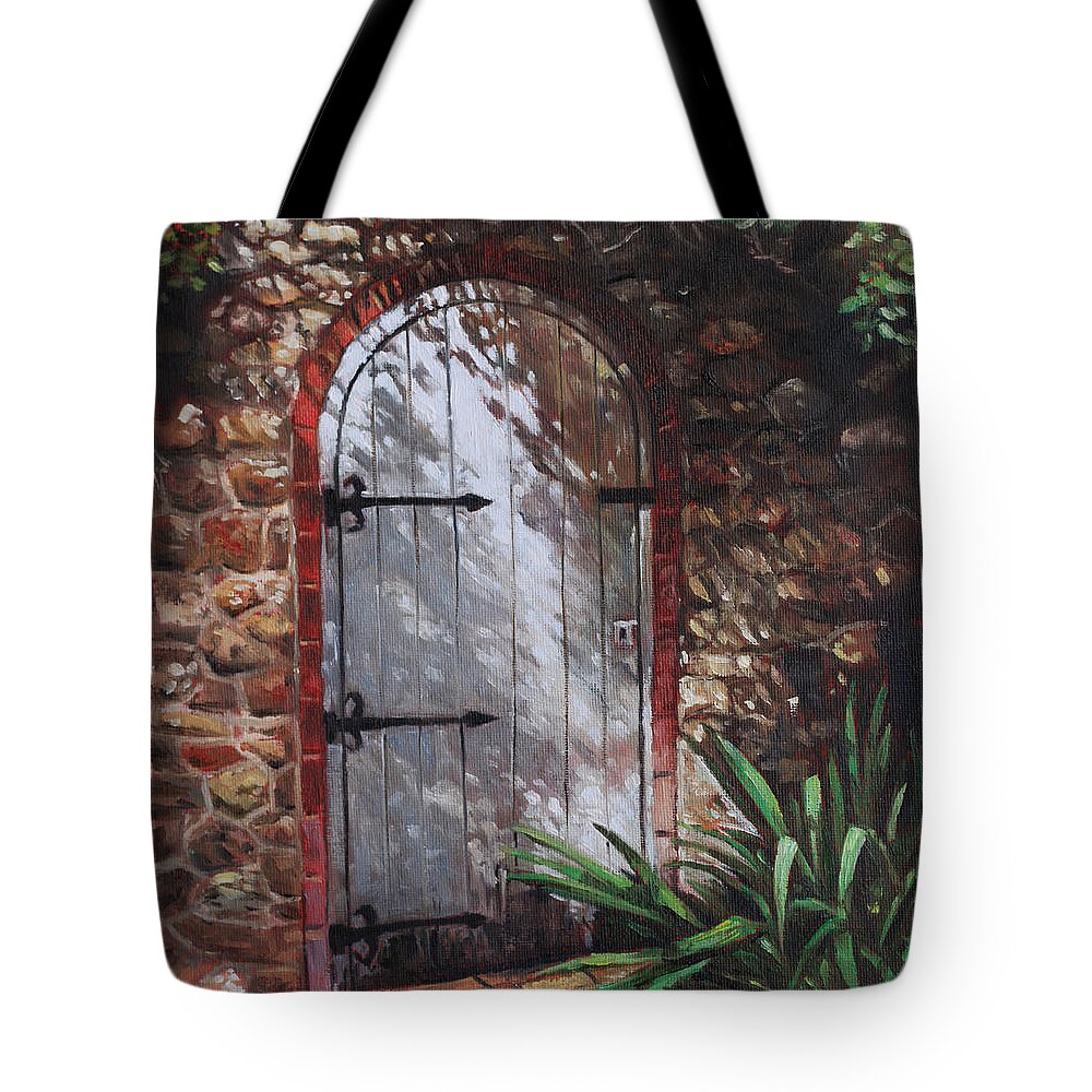 Door Tote Bag featuring the painting Decorative door in archway set in stone wall surrounded by plants by Martin Davey