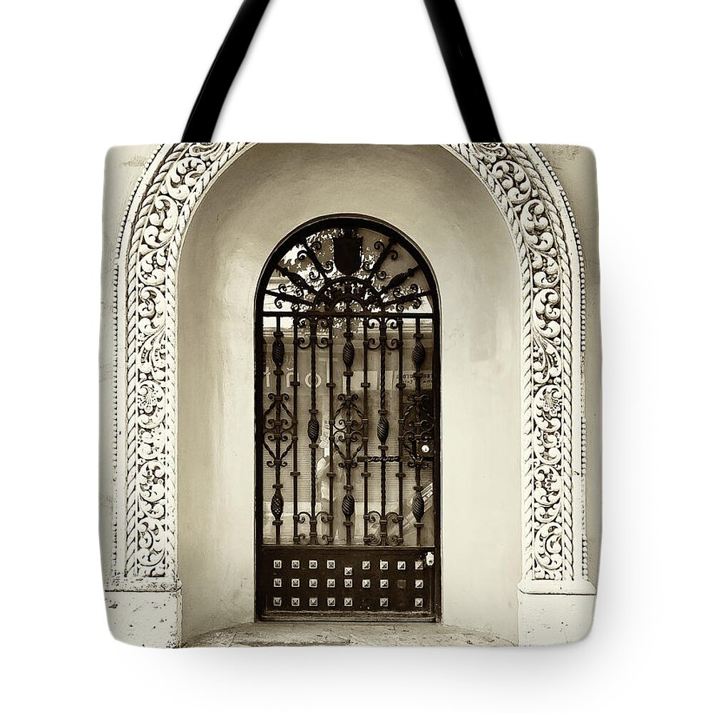 Architecture Tote Bag featuring the photograph Door with decorated arch by Roberto Pagani