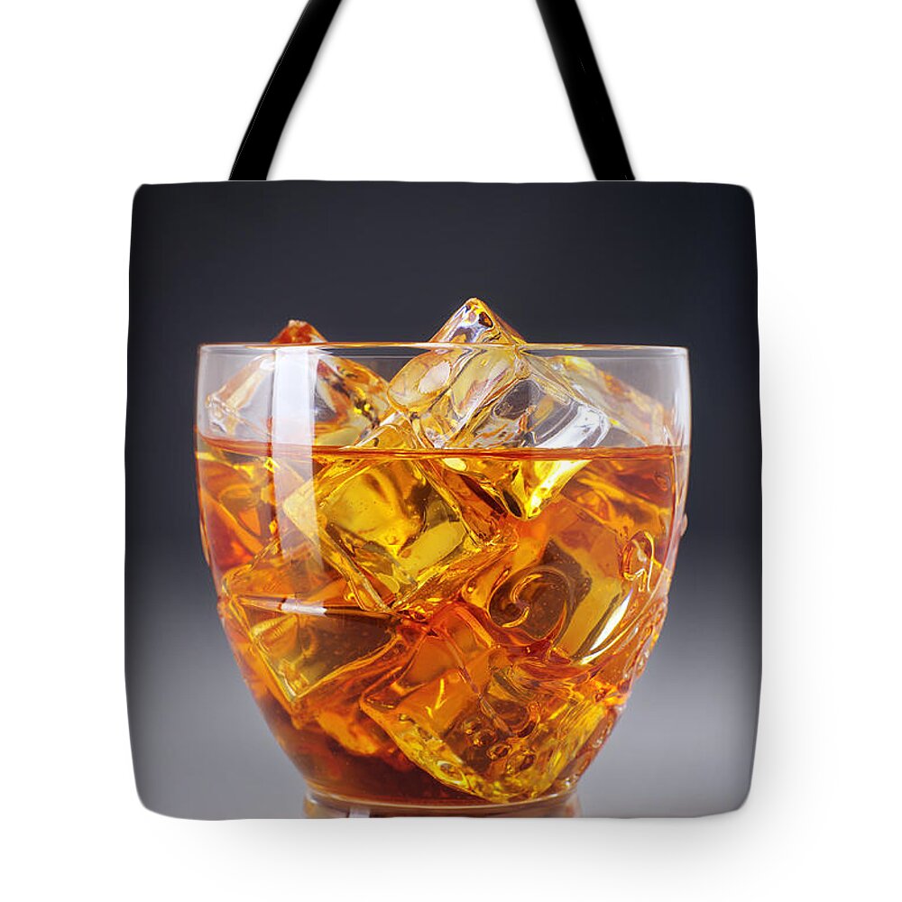 Alcohol Tote Bag featuring the photograph Drink on ice by Carlos Caetano